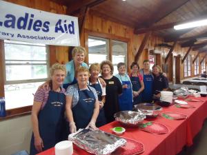 Carol Coyne (2nd from left) and Ladies Aid friends serve strawberry shortcake at the annual Strawberry Festival, June 2015.